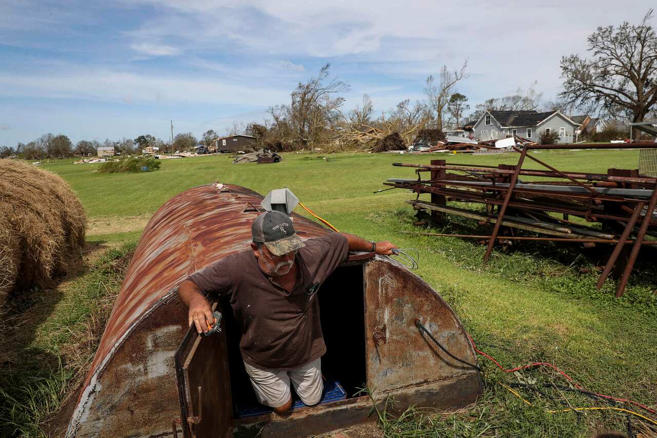 Ricky Thibadeaux emerges from a storm shelter where he and six others sheltered