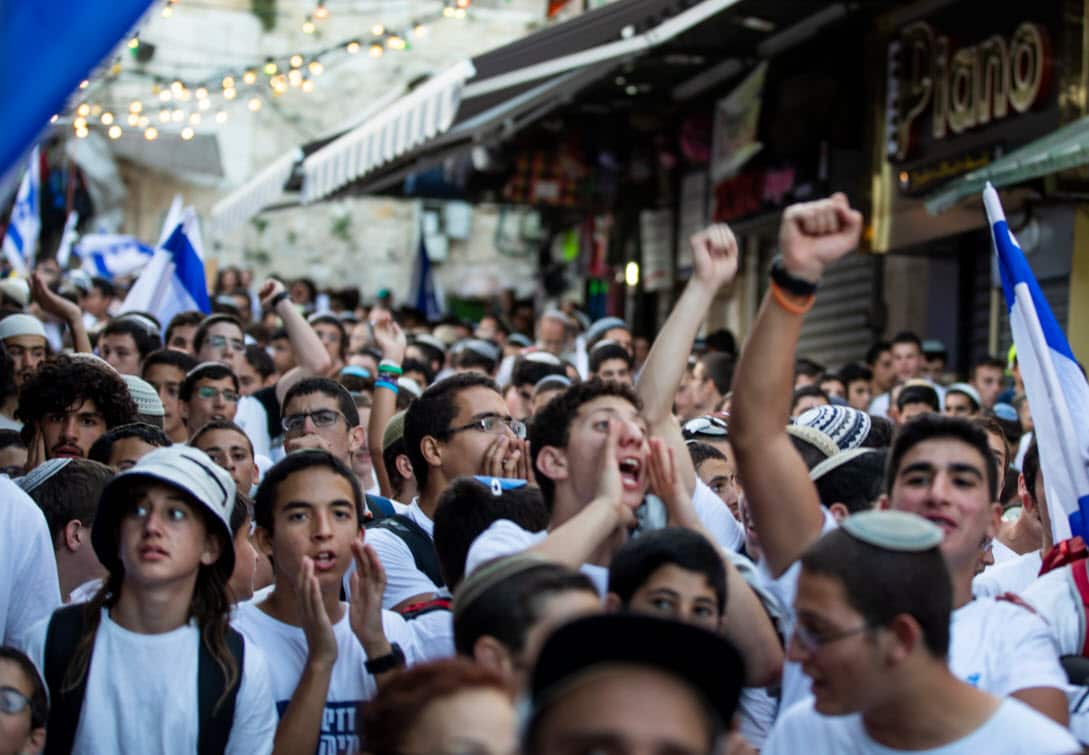 Israeli youth scream slogans and sing nationalistic Israeli songs (AAP)
