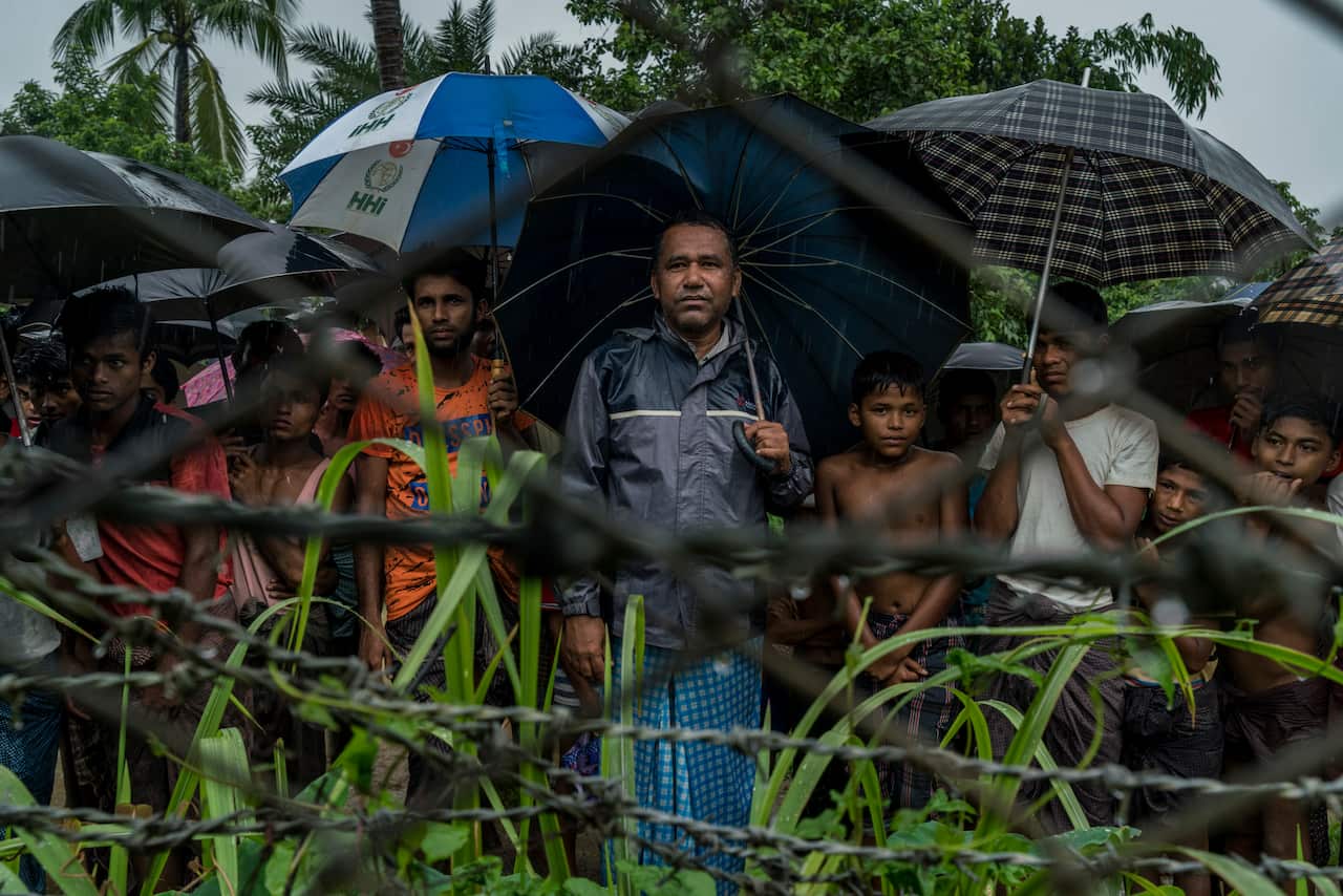 Rohingya Muslims behind barbed wire in the Taung Pyo border area where they are stranded between Myanmar and Bangladesh. 
