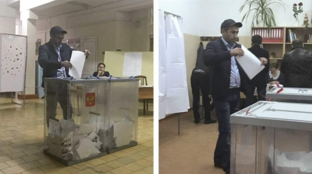 A voter casts his ballot at two separate polling stations.