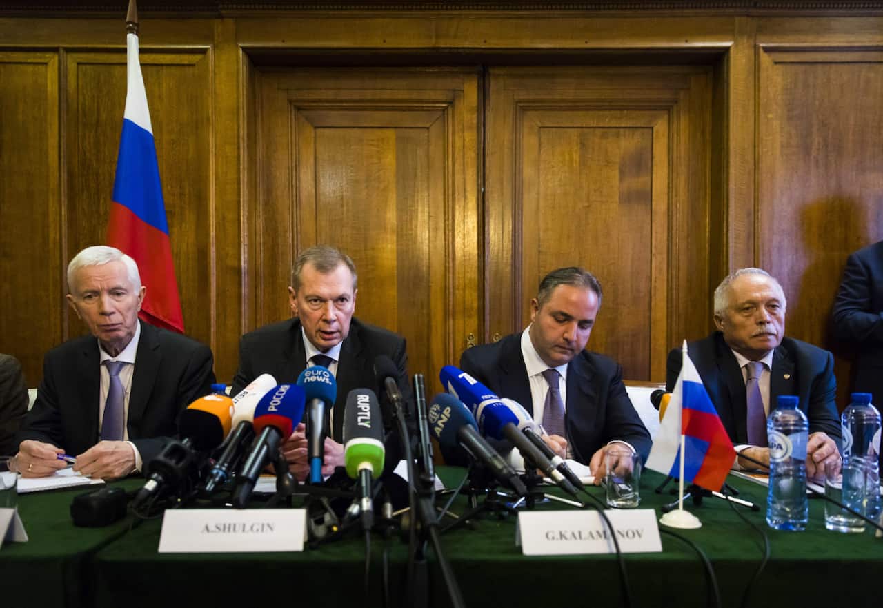 Russian ambassador Alexander Shulgin (C-L), Deputy Minister of Industry and Trade Georgy Kalamanov (C-R) and defense ministry experts at a press conference.