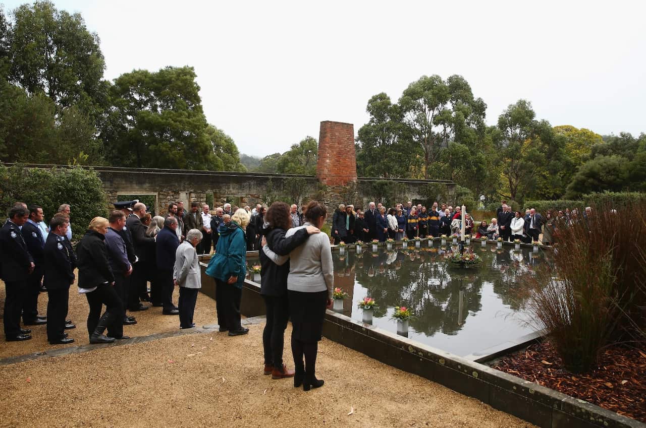 Family and community members lay 35 floral tributes in the Memorial Pool to remember the victims (Getty)