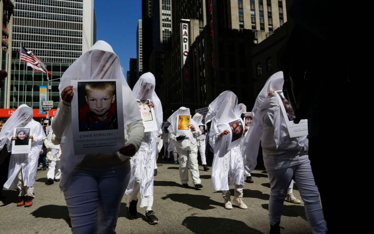 People carrying portraits of young victims of the Sandy Hook Elementary school massacre take part in the March for Our Lives Rally in New York.
