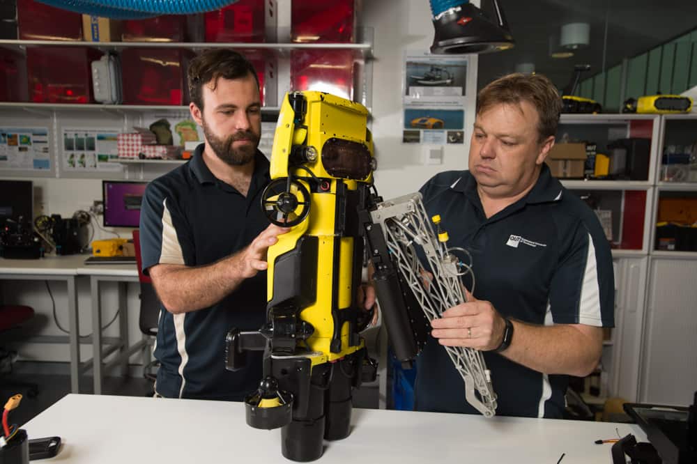 QUT Professor Matthew Dunbabin, right, with the RangerBot.