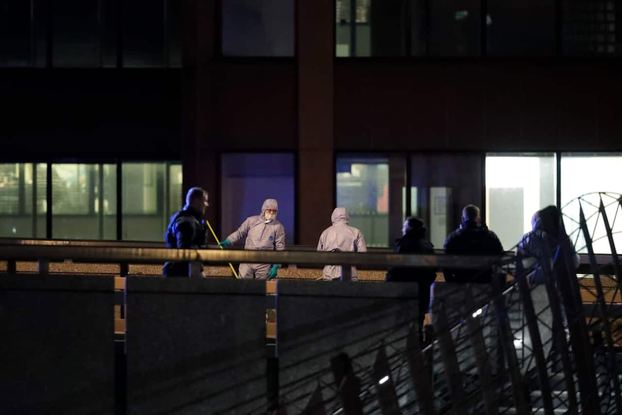 Police forensic officers work where a man was shot dead by police on London Bridge.