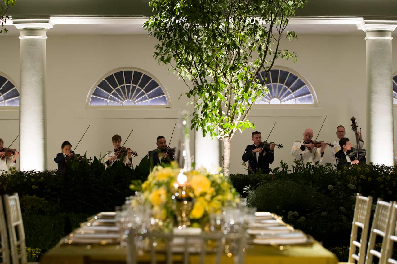 A table is set as a military band plays ahead of the state dinner.