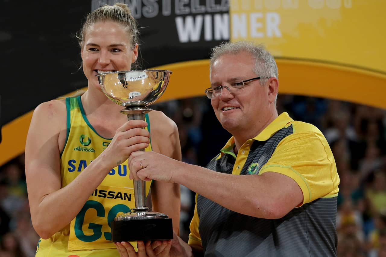 Prime Minister Scott Morrison presents the Constellation Cup to Caitlin Bassett of Australia in Perth on Sunday. 