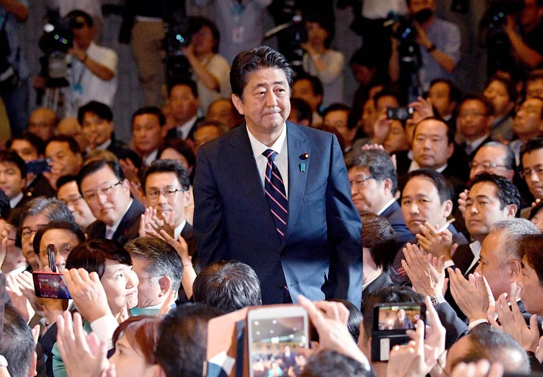 Prime Minister Shinzo Abe gets re-elected as president of his party in a landslide victory.