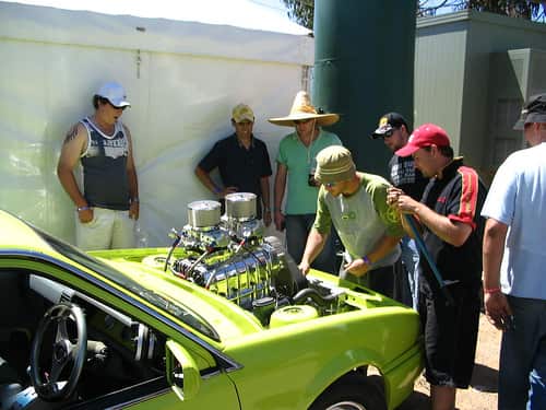 A group of men inspect a car during the Summernats festival in Canberra, Thursday, Jan. 2, 2014. The 27th hot car and burnout festival is held in Canberra from January 2-5, 2014.