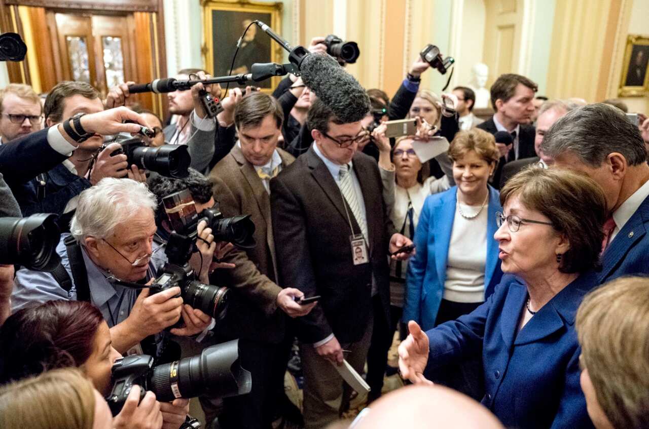 Sen. Susan Collins, R-Maine, second from right, accompanied by Sen. Joe Manchin, D-W.Va., right, and Sen. Jeanne Shaheen, D-N.H., third from right,