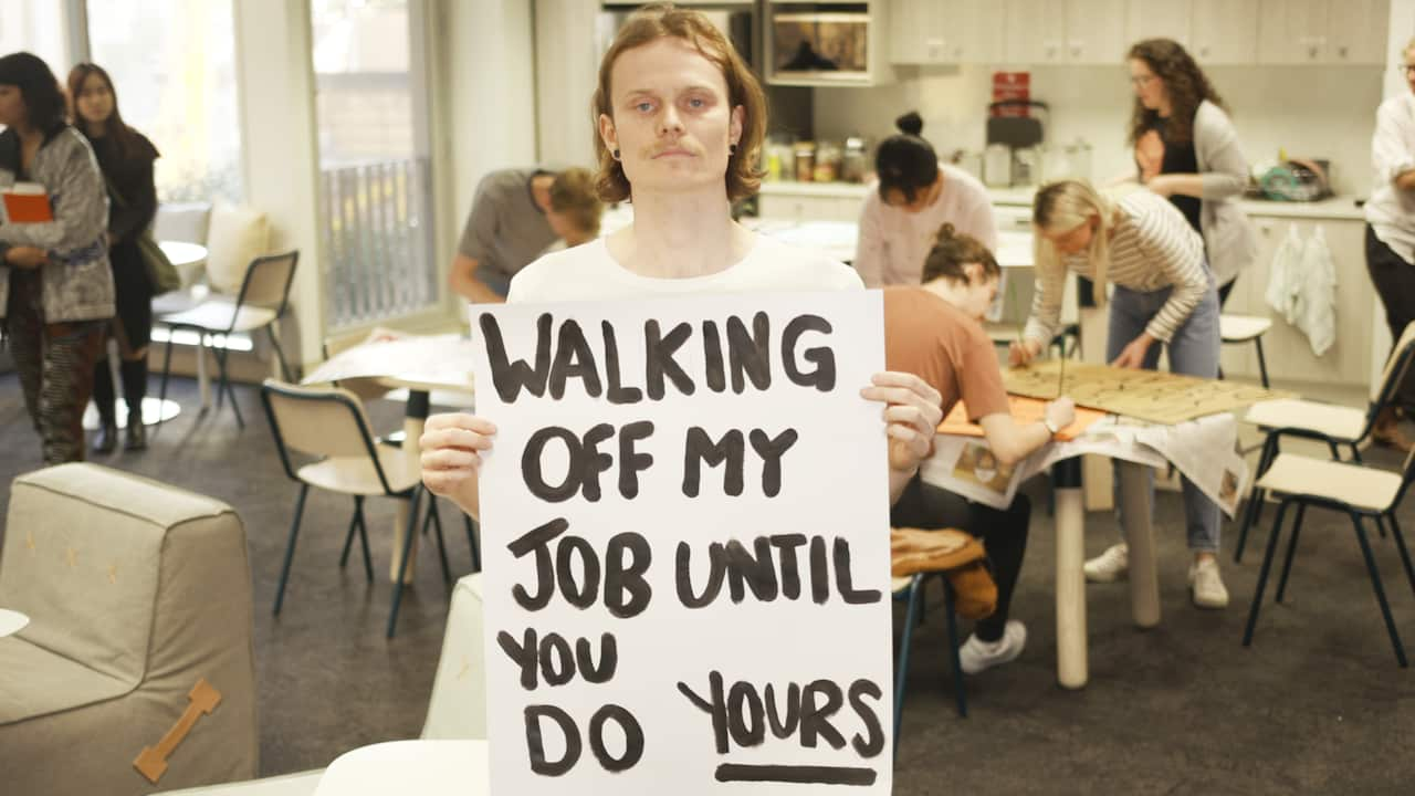 An employee of Future Super with the sign he created for the strike.