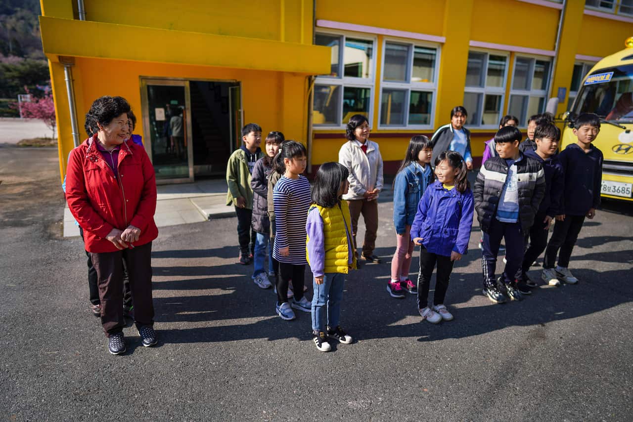 Hwang Wol-geum, 70, left corner, participates in a school trip with other grandmothers and her grandchildren in Gangjin County, South Korea. 