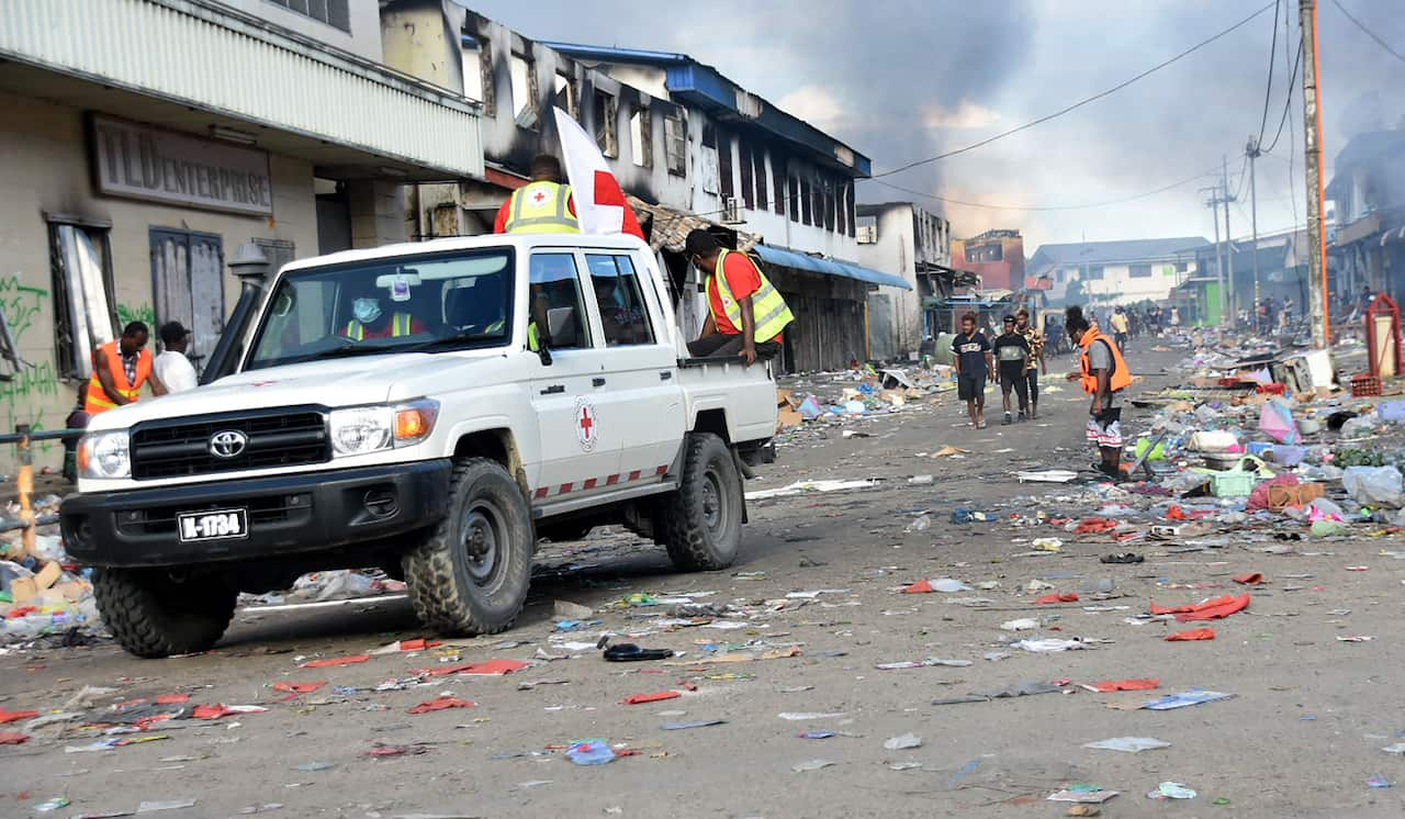 A Red Cross vehicle passes through the Chinatown district of Honiara on the Solomon Islands on 26 November, 2021.