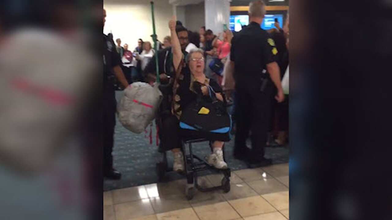 Woman removed from plane.
