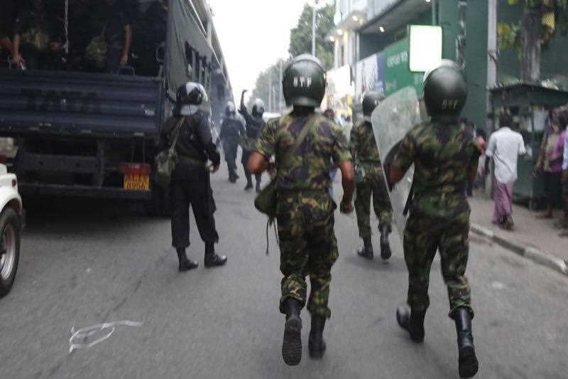 Riot police approach the mob. One man was shot, and several others injured, triggering protests.