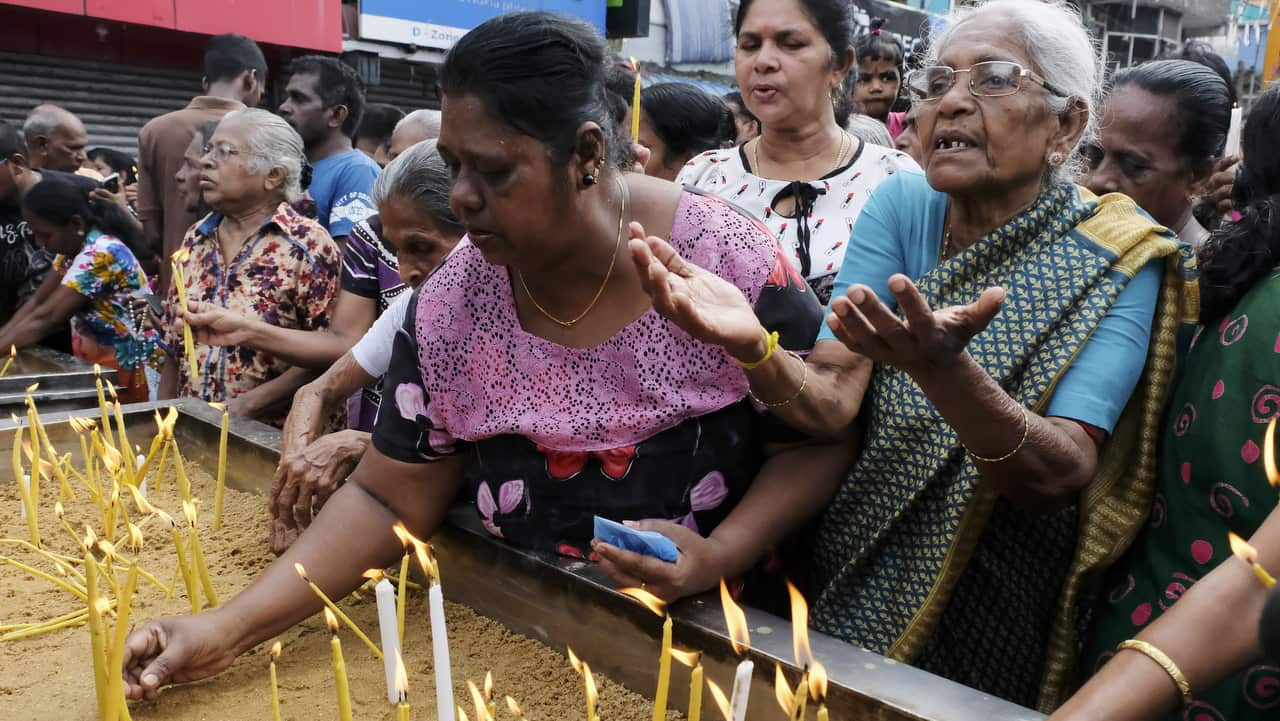 Devotees offer prayers outside the St. Anthony's Church where blast took place.