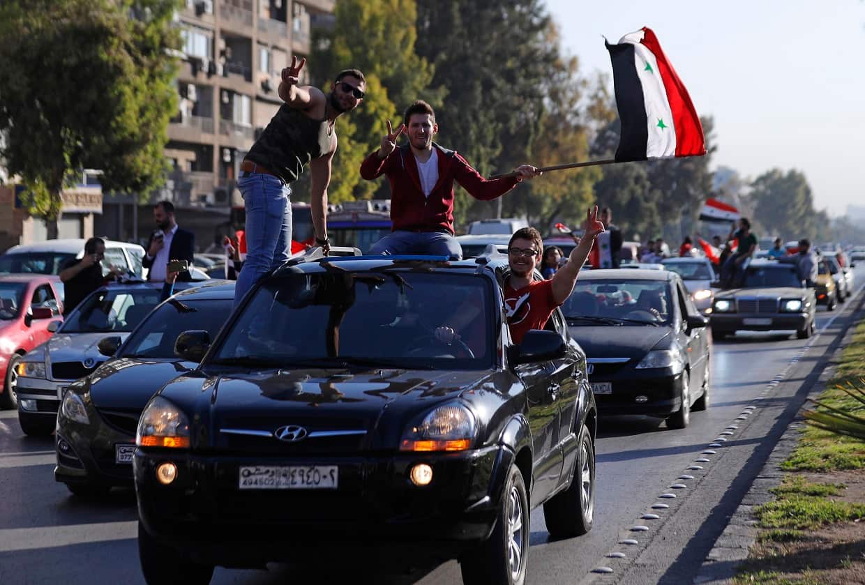 Syrian government supporters chant slogans against US President Trump during demonstrations following a wave of military strikes.