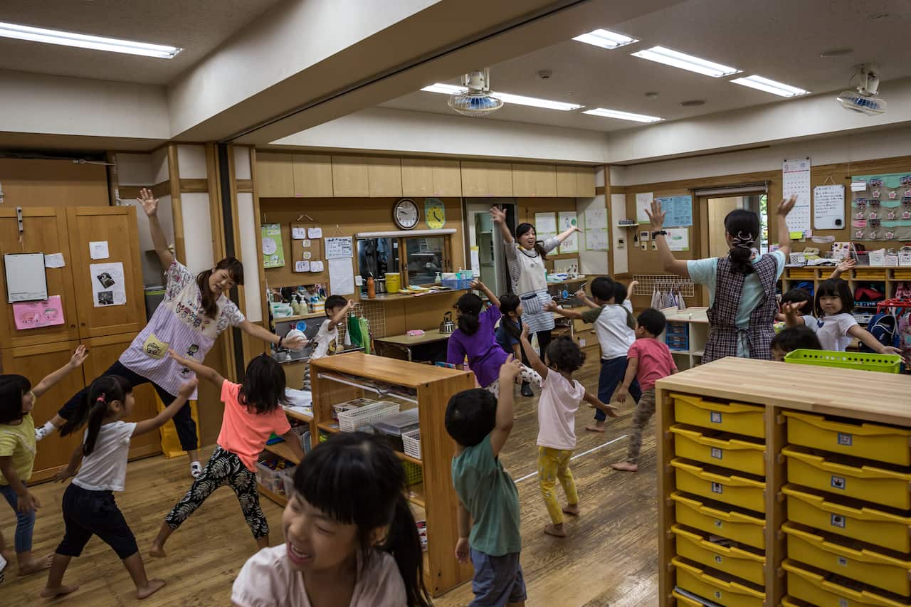 Teachers lead children in a dancing activity in Midorigaoka Nursery School in west Tokyo.
