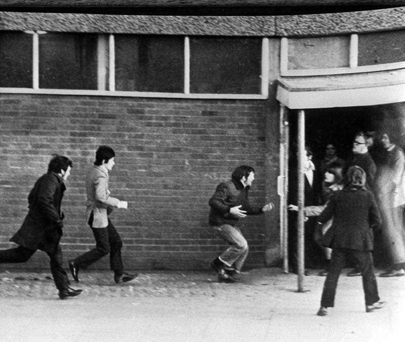 Hugh Gilmore (third left) clutching his stomach after he was shot during Bloody Sunday. 