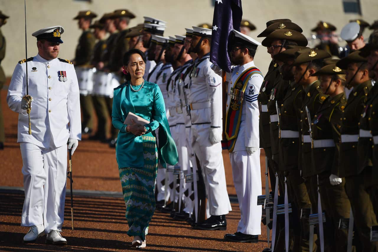 Myanmar's State Counsellor Aung San Suu Kyi inspects the guard during a ceremonial welcome at Parliament House in Canberra