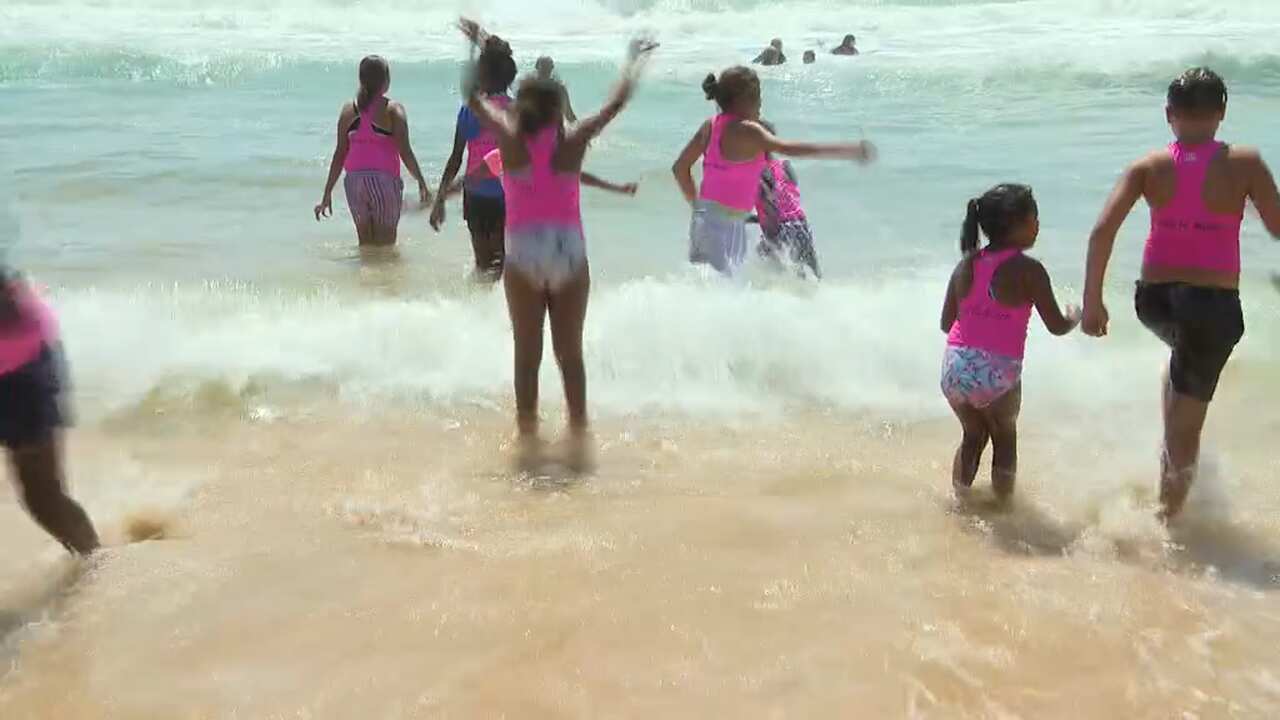 The kids enjoy the 35 degree day by the water.