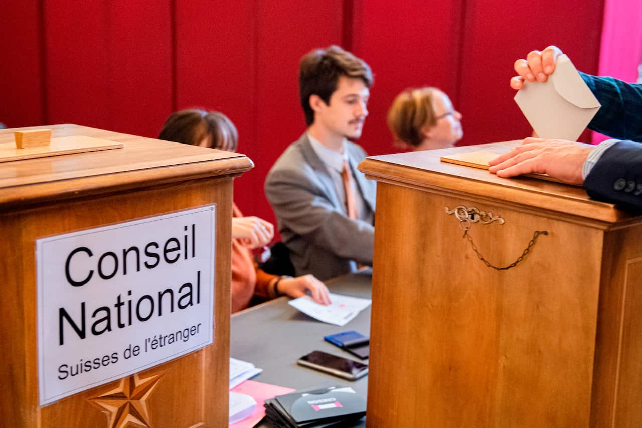 People voting in the municipal office in Sion, Swizerland during the 2019 Swiss federal elections.