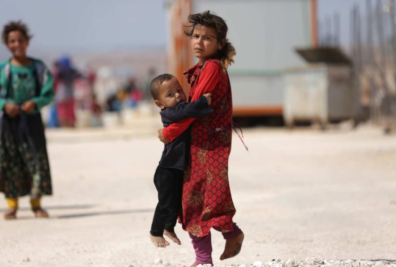 Children who fled Syria's Idlib province are pictured at a camp in Kafr Lusin near the border with Turkey in the northern part of the province on September 9, 2018