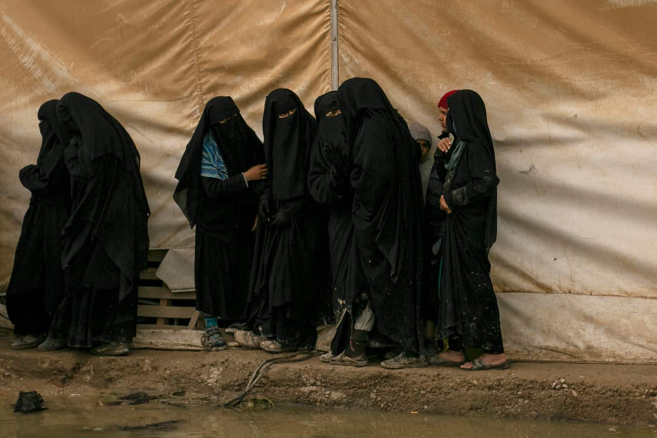 Women queue for aid supplies at al-Hol camp, home to Islamic State-affiliated families near Hasakeh, Syria.