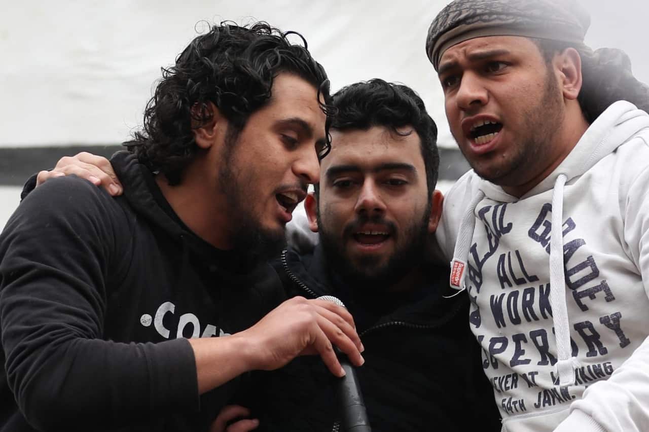 Syrian rebel fighter Abdel-Basset al-Sarout, left, sings on 15 March 15 during a rally to commemorate the beginning of the Syrian revolution (AFP)