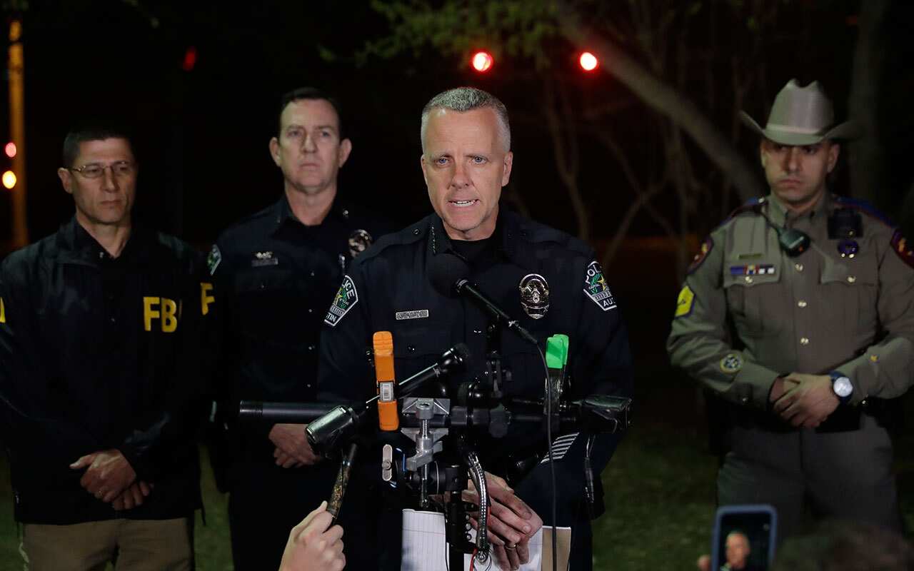 Interim Austin police Chief Brian Manley, center, talks to the media after another explosion, early Monday, March 19, 2018, in Austin, Texas.