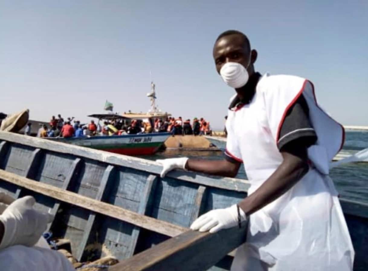  handout photo made available by the Tanzania Red Cross shows Red Cross volunteers during rescue operation near Ukerewe island in Lake Victoria, Tanzania