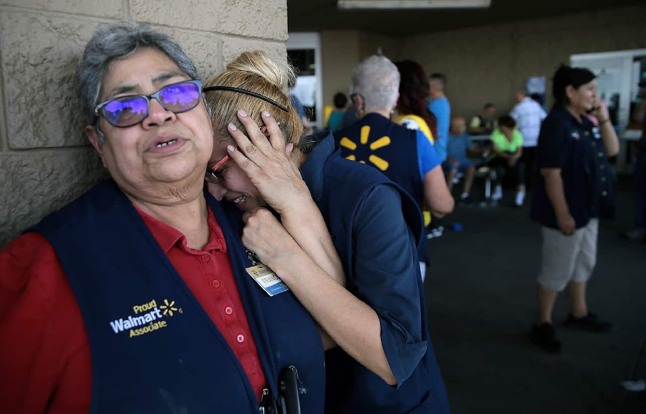Walmart employees react after an active shooter opened fire at the store in El Paso, Texas, Saturday, Aug. 3, 2019.