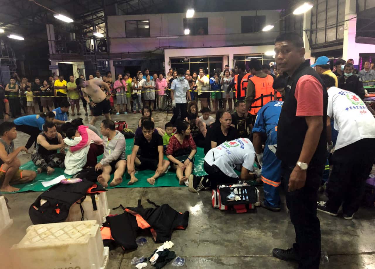 Medical teams attend to rescued tourists from the boat.