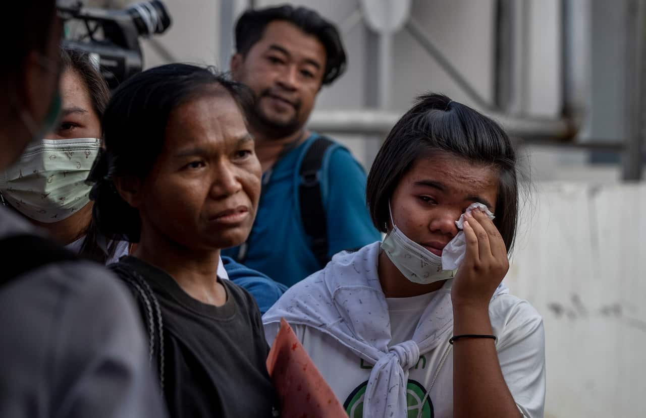 Relatives of the mass shooting's fatalities wait outside a morgue at Korat, Nakhon Ratchasima.