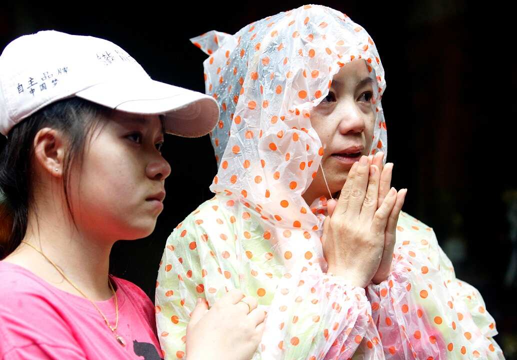 Thai family members and relatives of missing football players and their coach pray that they will be found alive.