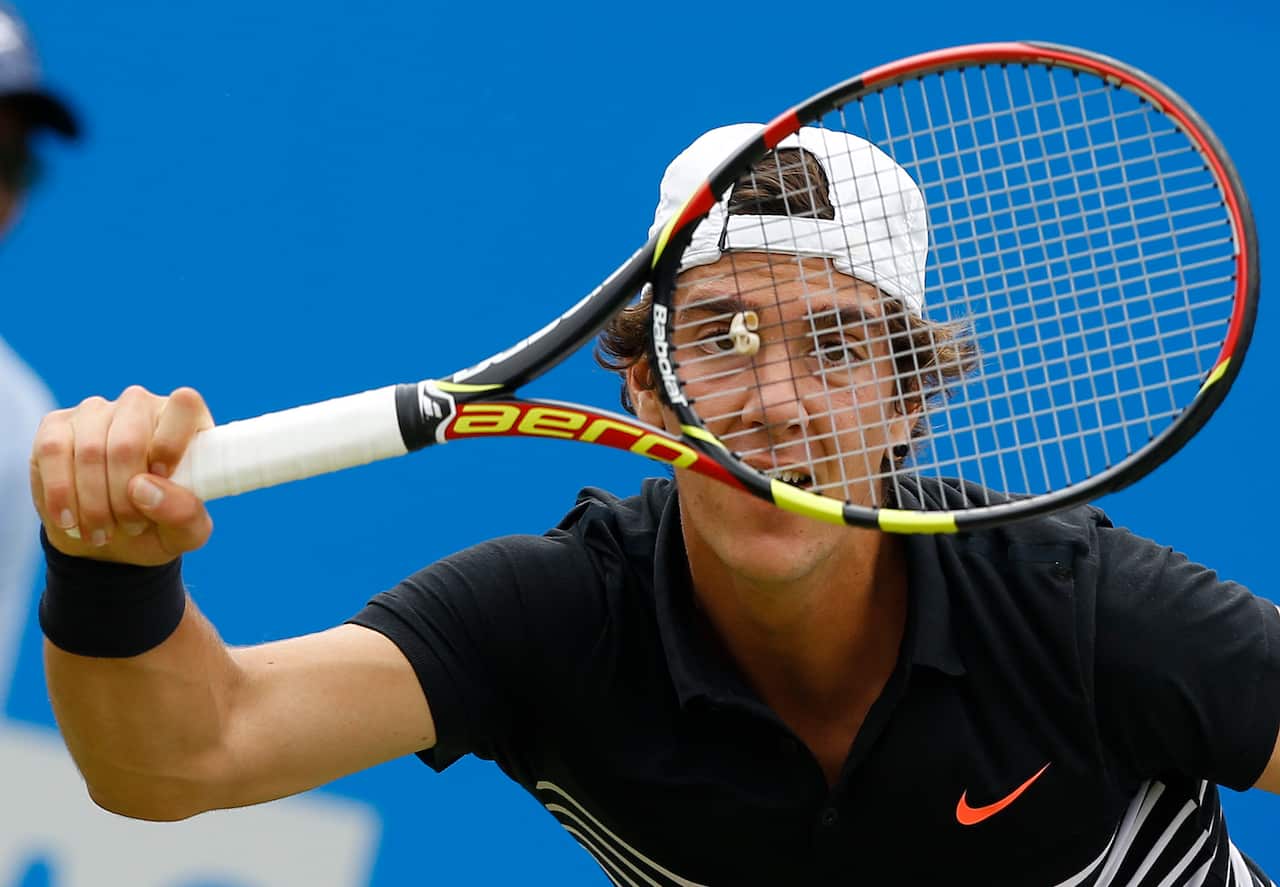 Thanasi Kokkinakis of Australia plays a return to Gilles Simon of France during their singles tennis match at the Aegon Championships in London, Wednesday, June 17, 2015. (AP Photo/Kirsty Wigglesworth)