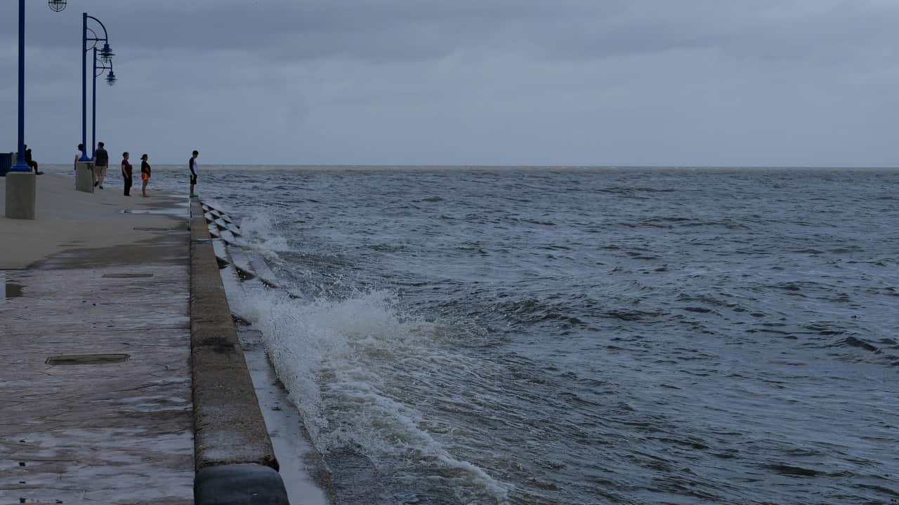 People watch as winds from Tropical Storm Barry churn the waters of Lake Pontchartrain in New Orleans.