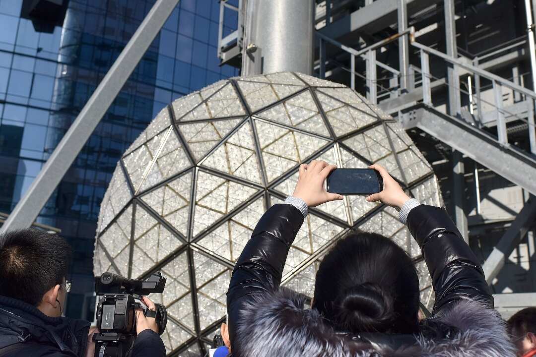 Workers install one of the panels holding some of the 192 new Waterford Crystal Triangles on the 2019 NYE Ball atop One Times Square in New York.