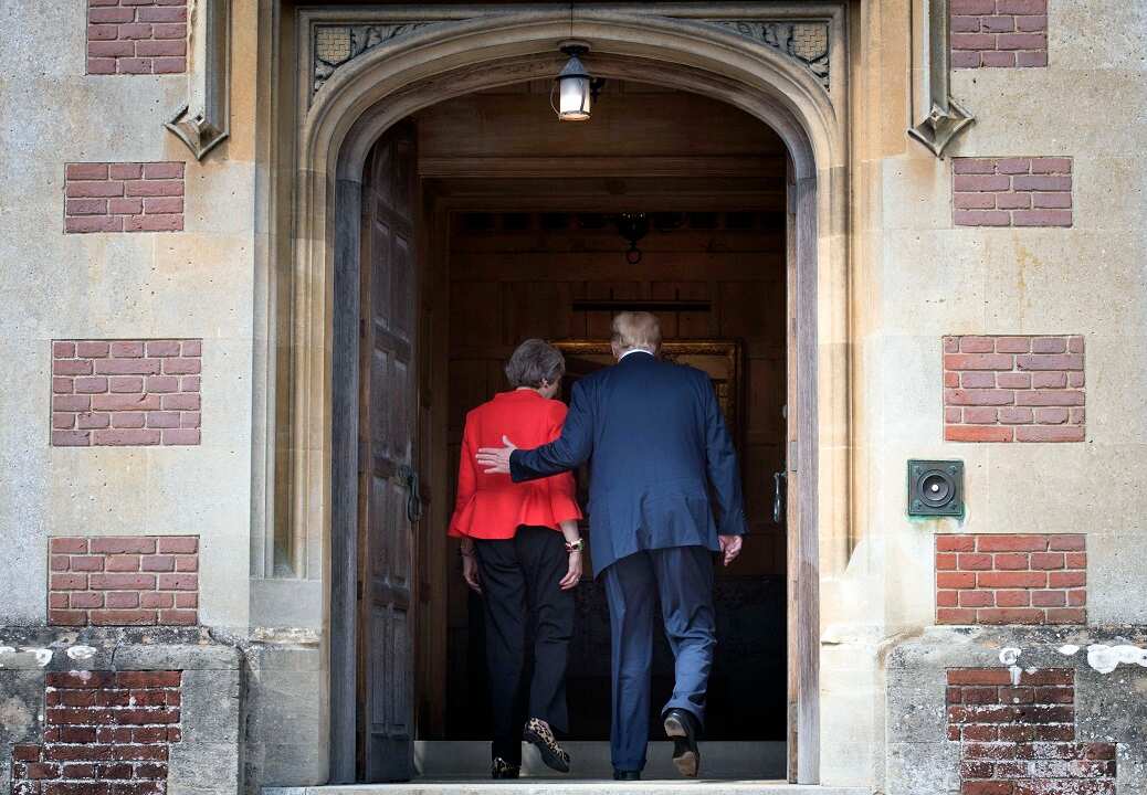 Prime Minister Theresa May and US President Donald Trump walk through the doors at Chequers.