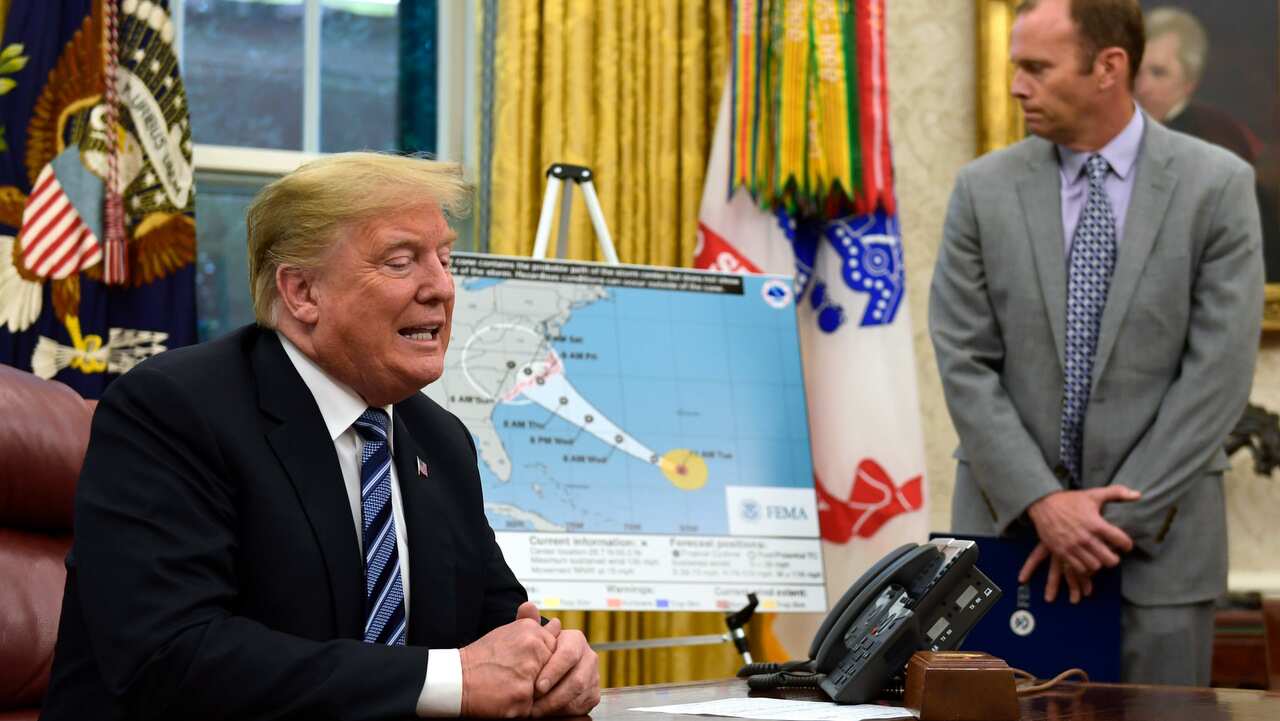 President Donald Trump, left, talks about Hurricane Florence during a briefing in the Oval Office of the White House.