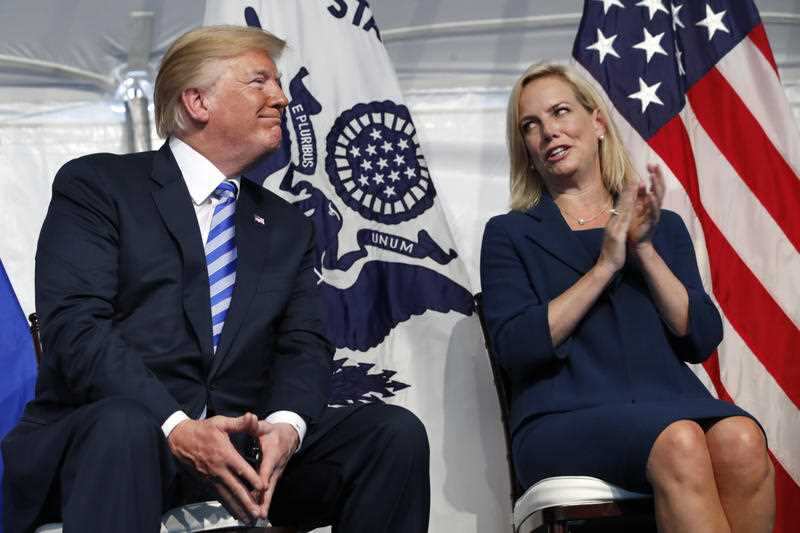 Homeland Security Secretary Kirstjen Nielsen, right, applauds President Donald Trump as they attend a Change of Command ceremony at the US Coast Guard HQ. 