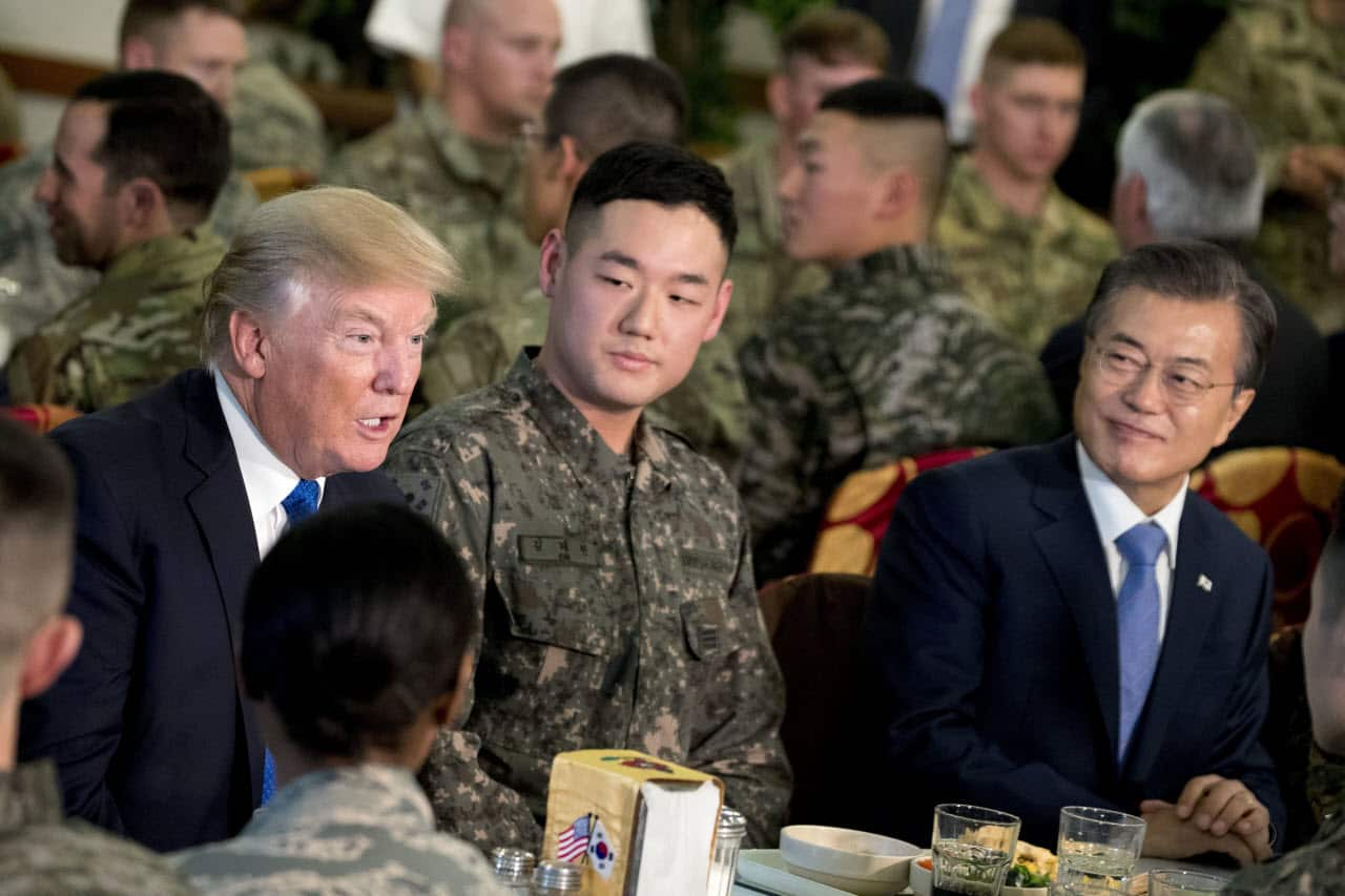 President Donald Trump, left, and South Korean President Moon Jae-in, right, have lunch with U.S. and South Korean troops.