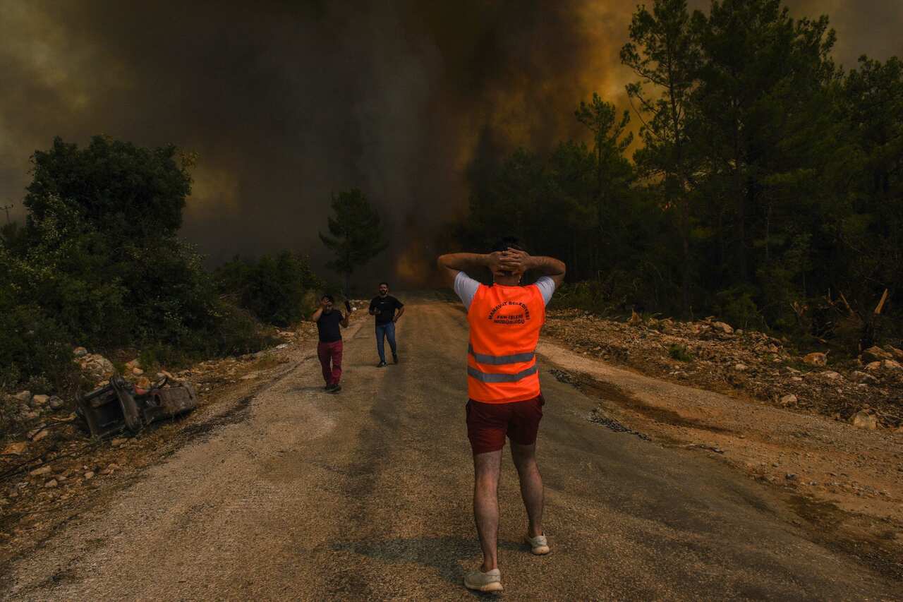 People flee a fire at Sirtkoy village, near Manavgat in Turkey.