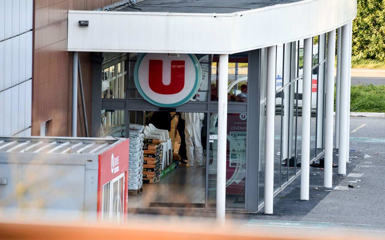French security and forensic officers are seen inside the Super U supermarket in the town of Trebes, southern France, where a man took hostages