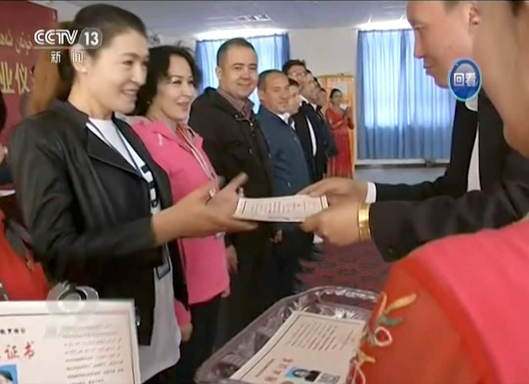 China's CCTV showed smiling Muslims graduating from the 'education centres' but human rights groups say many are being held against their will.