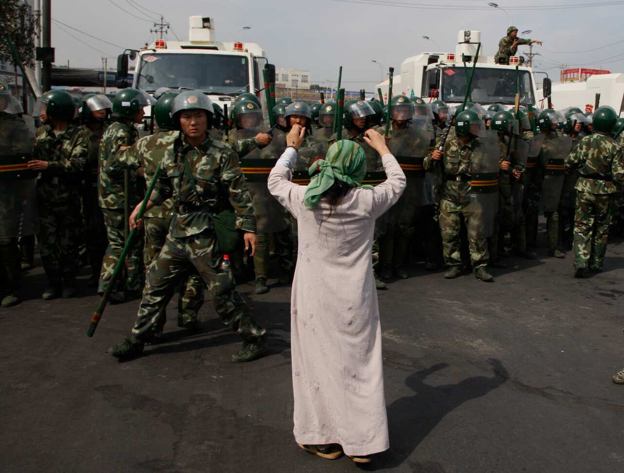A Uighur woman protests before a group of Chinese paramilitary police in 2009.