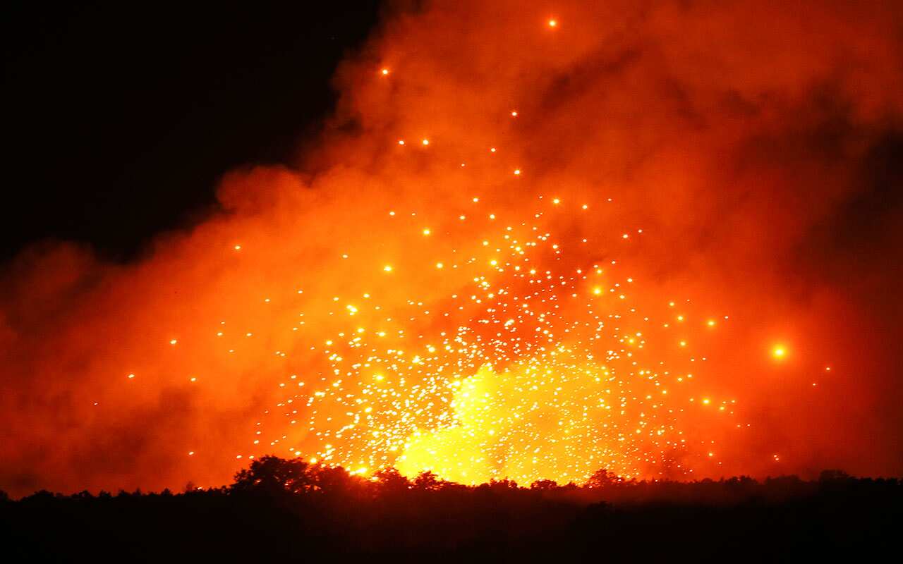 A powerful explosion is seen in the ammunition depot at a military base in Kalynivka, west of Kiev, Ukraine, early Wednesday, Sept. 27, 2017. 