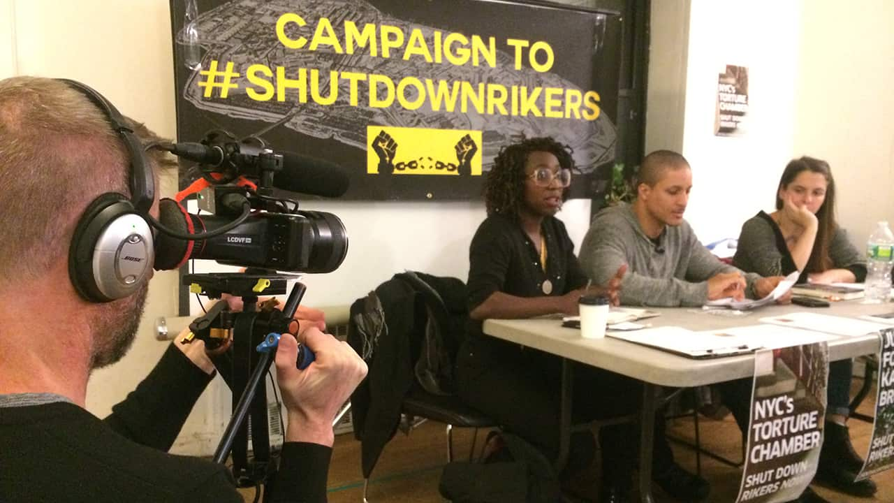 Akeem (centre) is now part of a campaign to shut down Rikers Island prison.