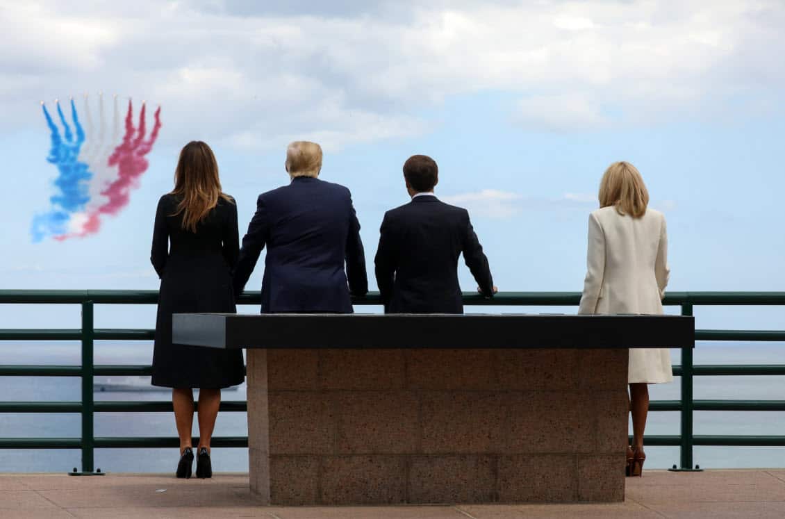US First Lady Melania Trump, US President Donald Trump, French President Emmanuel Macron and French President's wife Brigitte Macron watch as French elite acrobatic flying team Patrouille de France fly over (AAP)