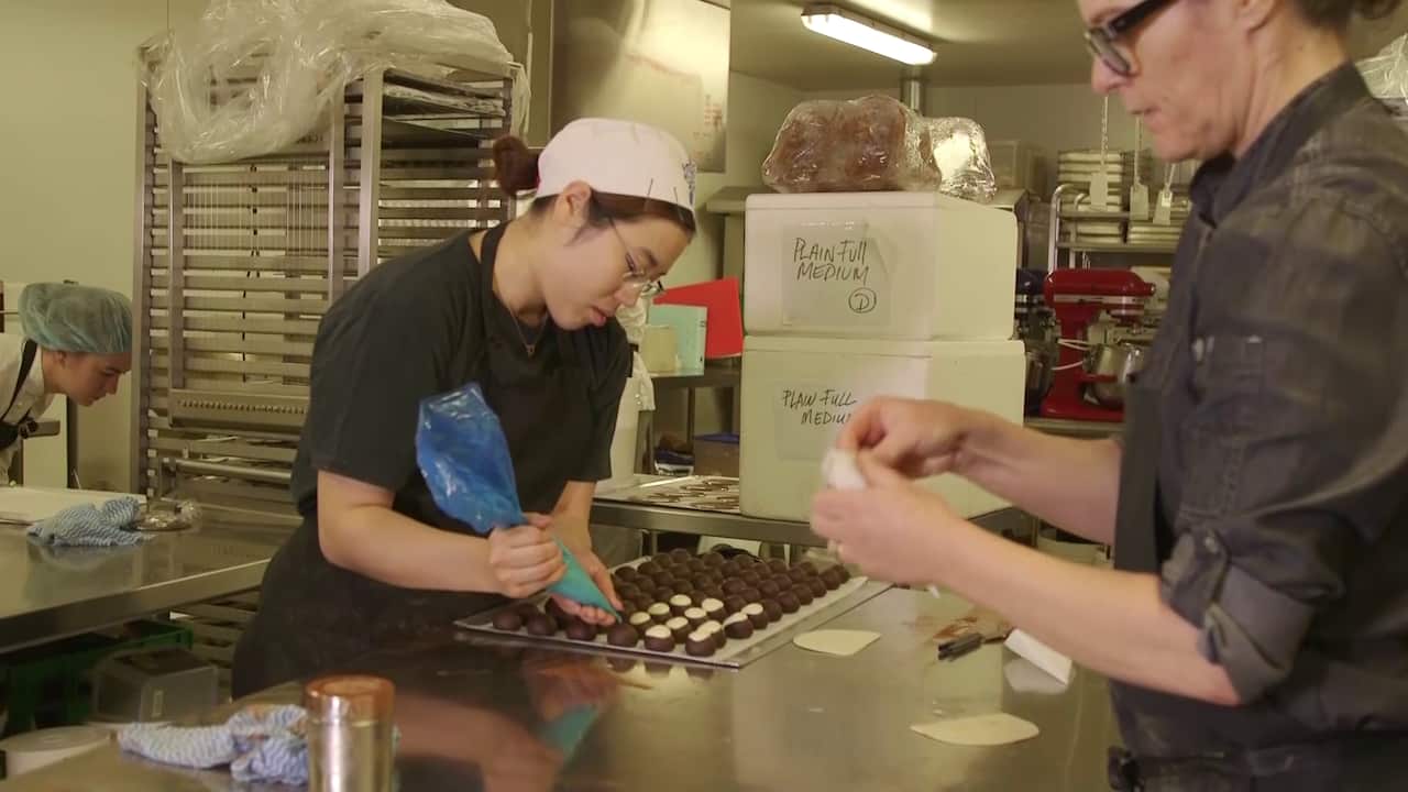 Adora employees decorating chocolates